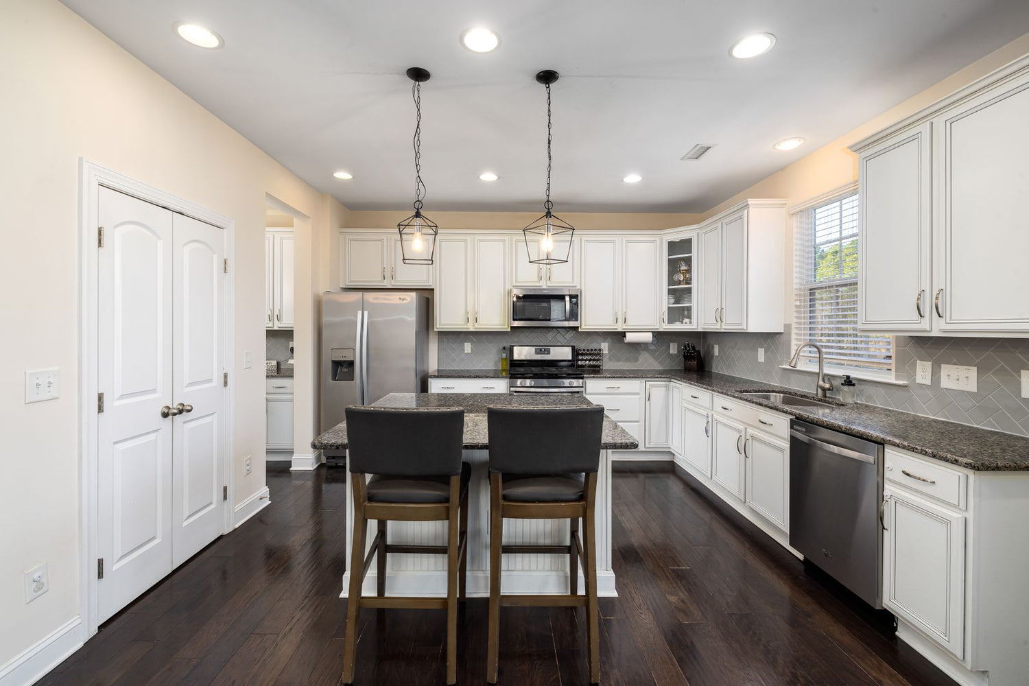 Modern white kitchen with recessed ceiling lighting